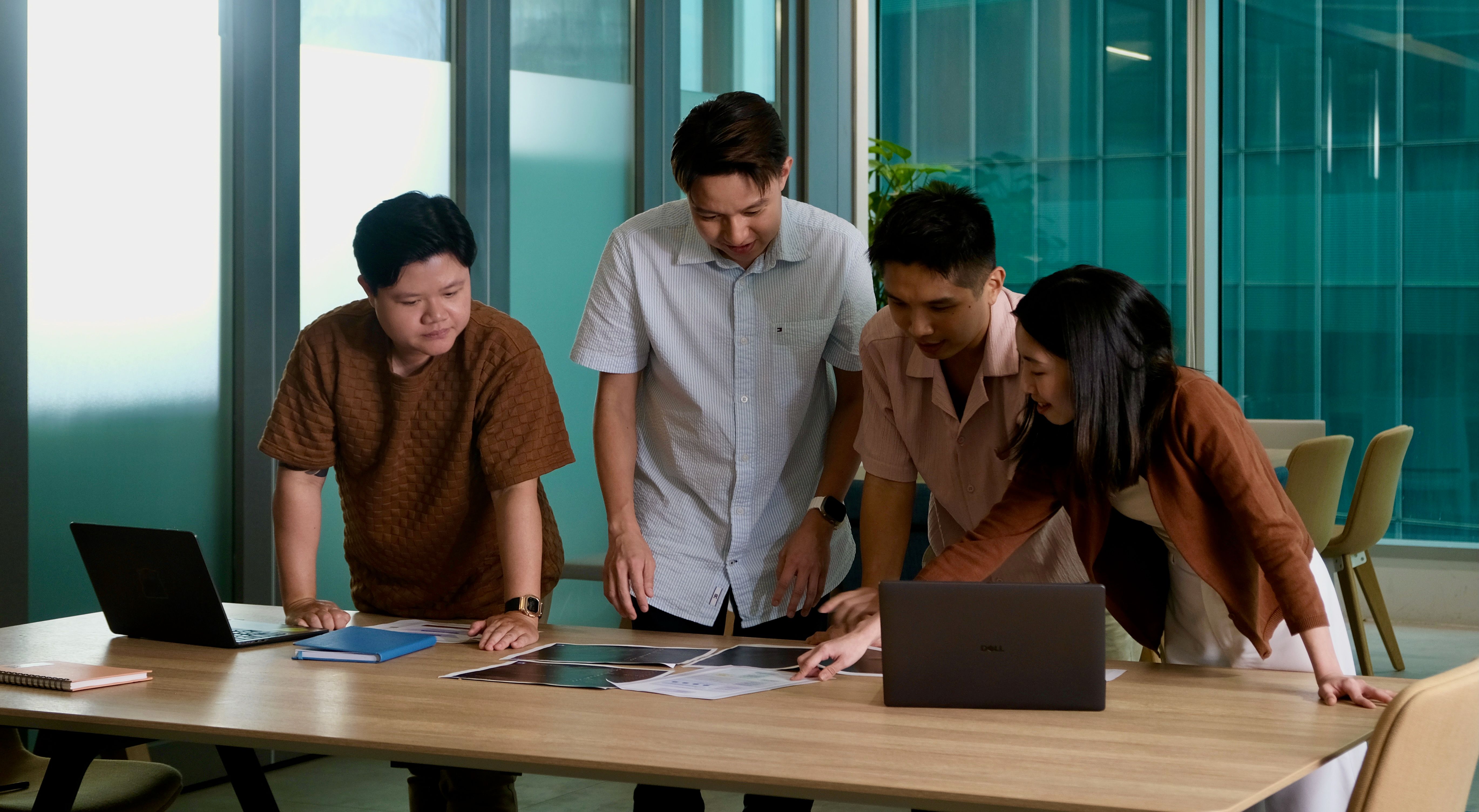 A group of graduates pose together for a group photo in a TikTok office.