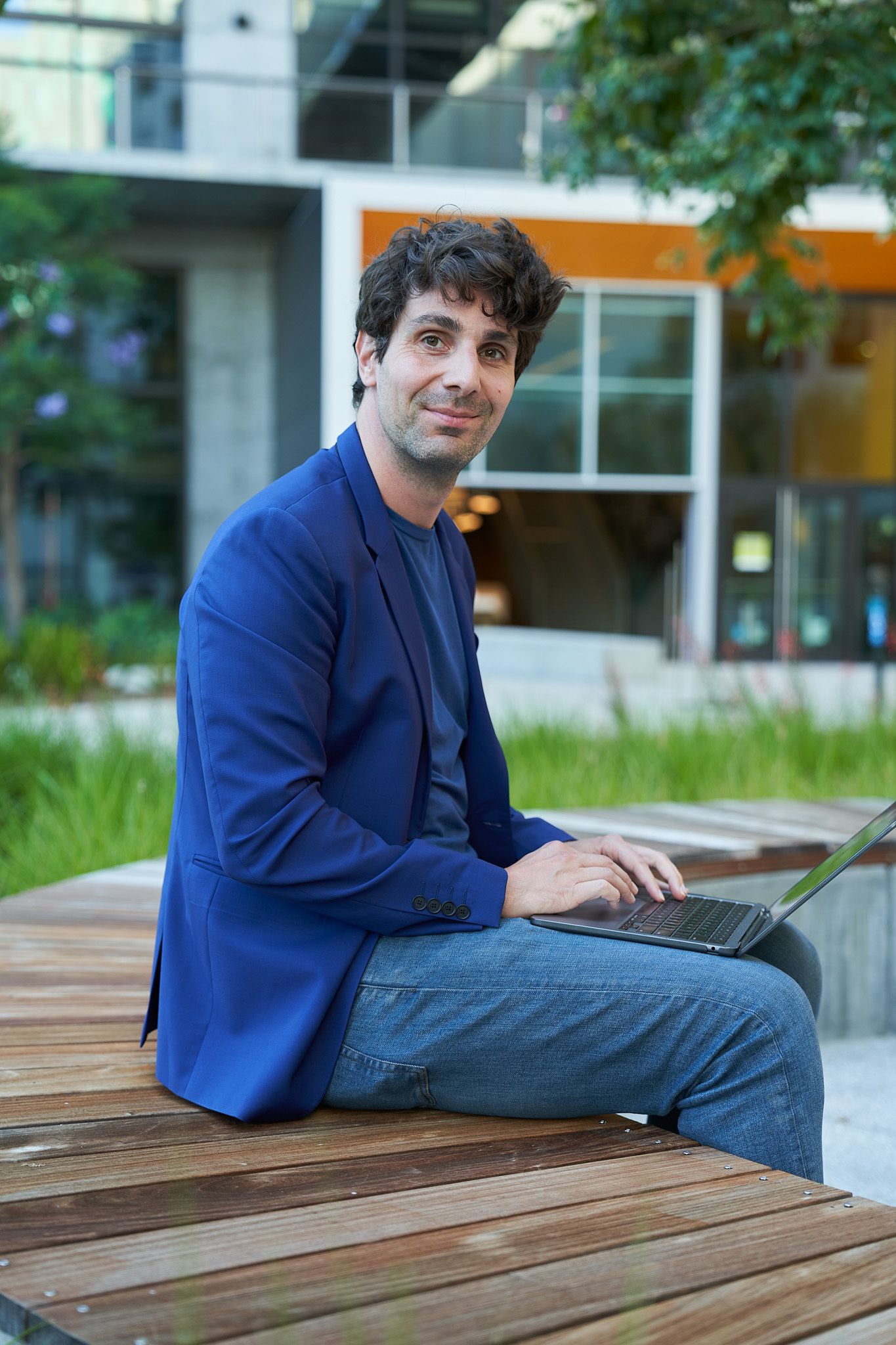 Two young female ByteDance employees smile as they work at their laptops.